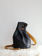 1 of 1 Luna Crossbody Adjustable Cinch Top Leather Backpack | swallowtail black image 0